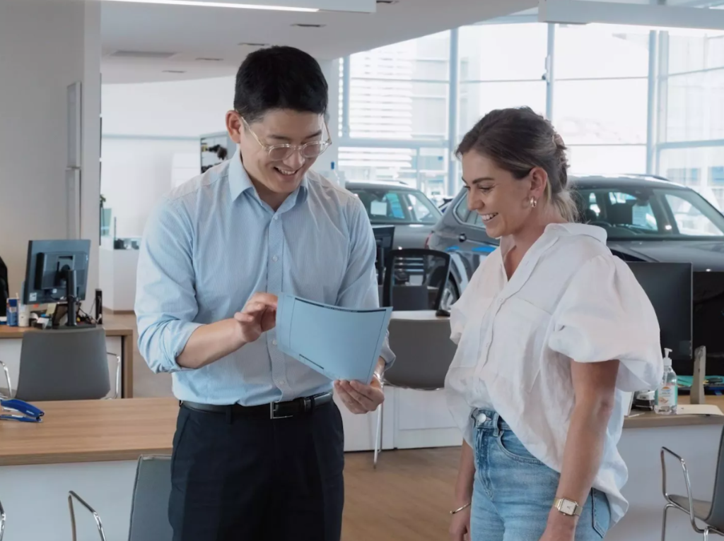 Man and women looking at document smiling